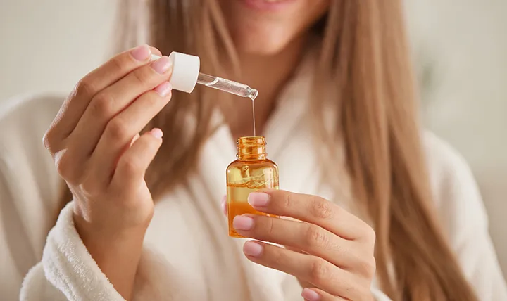Woman Using hair oil